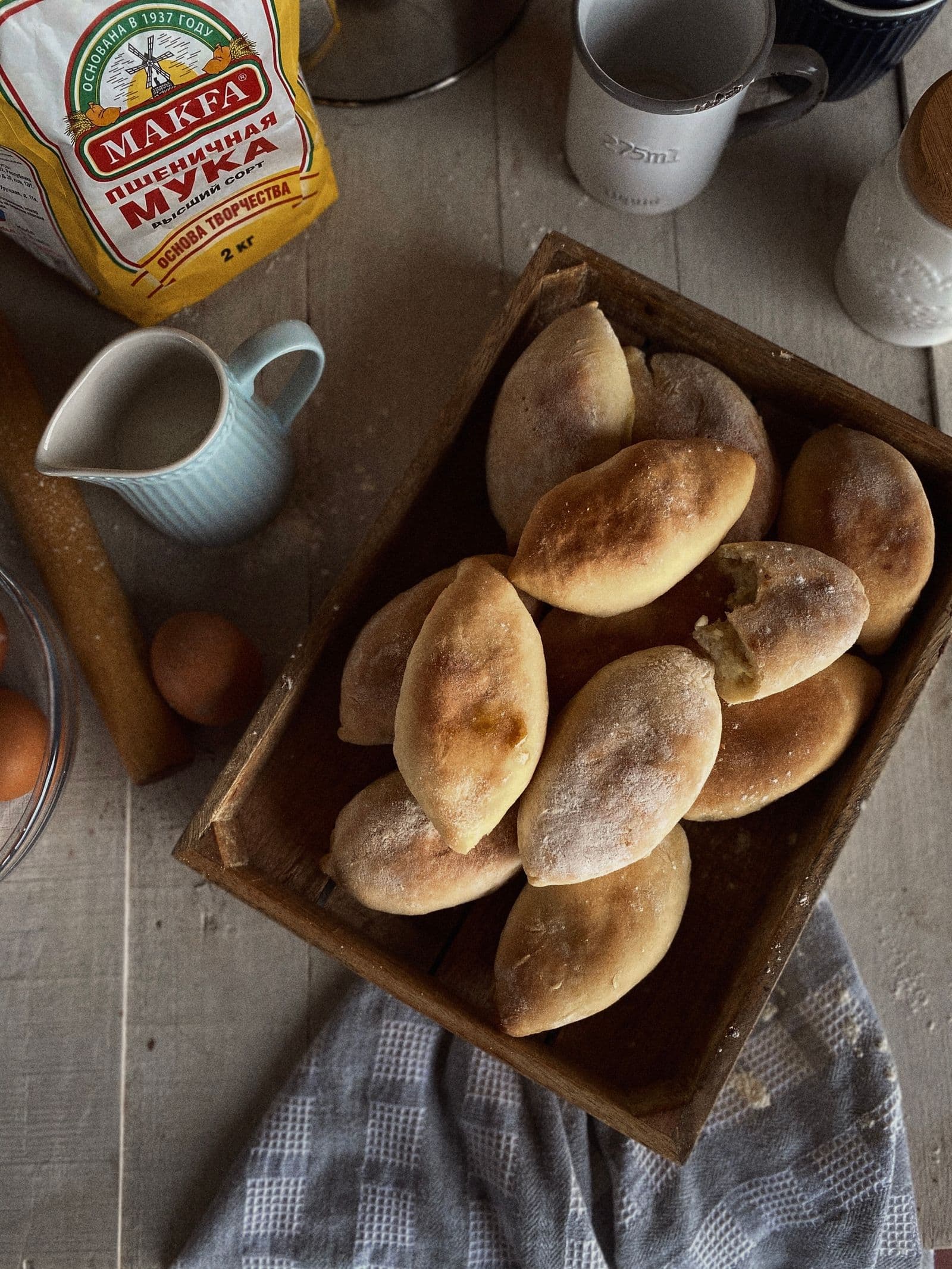 A wooden tray of freshly baked pirozhki