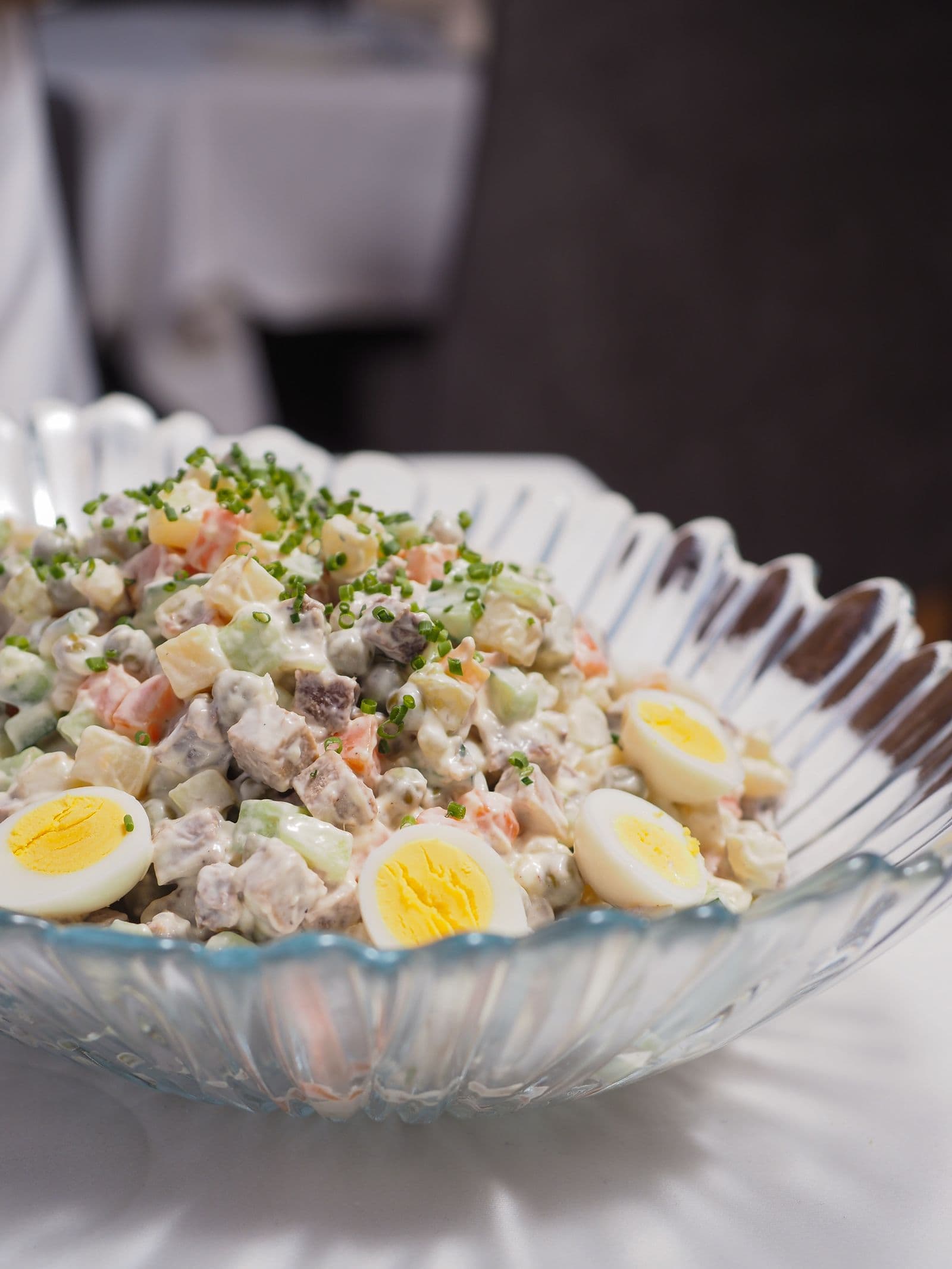 Olivier salad with eggs in a crystal bowl